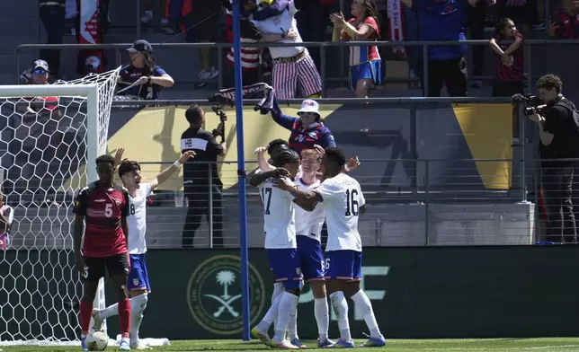 United States forward Malik Tillman, center left, celebrates with teammates after scoring against Trinidad and Tobago during the first half of a CONCACAF Gold Cup soccer match in San Jose, Calif., Sunday, June 15, 2025. (AP Photo/Jeff Chiu)