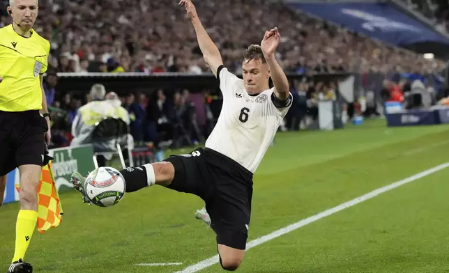 Germany's Joshua Kimmich fails to stop the ball from going over the line during the Nations League semifinal soccer match between Portugal and Germany at the Munich Football Arena, in Munich, Germany, Wednesday, June 4, 2025. (AP Photo/Martin Meissner)