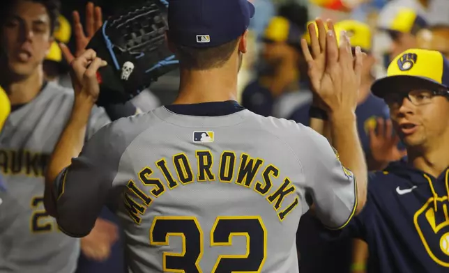 Milwaukee Brewers starting pitcher Jacob Misiorowski (32) returns to the dugout after giving up a two-run home run to the Minnesota Twins in the seventh inning of a baseball game Friday, June 20, 2025, in Minneapolis. (AP Photo/Bruce Kluckhohn)