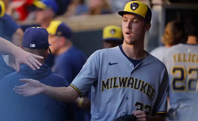 Milwaukee Brewers starting pitcher Jacob Misiorowski (32) returns to the dugout after throwing against the Minnesota Twins in the third inning of a baseball game Friday, June 20, 2025, in Minneapolis. (AP Photo/Bruce Kluckhohn)