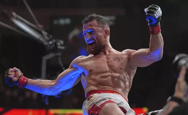 Georgia's Merab Dvalishvili, left, celebrates after winning his bantamweight title bout against Sean O'Malley at the UFC 316 mixed martial arts event Sunday, June 8, 2025 in Newark, N.J. (AP Photo/Frank Franklin II)