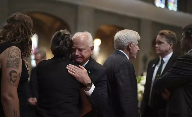 Gov. Tim Walz greets attendees before funeral services for Mark and Melissa Hortman at the Basilica of St. Mary in Minneapolis, Minn., on Saturday, June 28, 2025. (Alex Kormann/Star Tribune via AP, Pool)