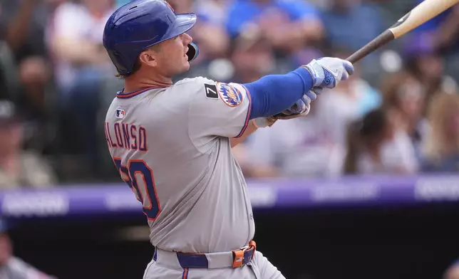 New York Mets' Pete Alonso follows the flight of his two-run home run off Colorado Rockies relief pitcher Tyler Kinley in the eighth inning of a baseball game Sunday, June 8, 2025, in Denver. (AP Photo/David Zalubowski)