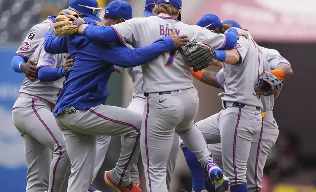 New York Mets players celebrate after defeating the Colorado Rockies in a baseball game Sunday, June 8, 2025, in Denver. (AP Photo/David Zalubowski)