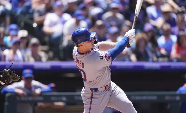 New York Mets' Pete Alonso follows the flight of his two-run home run off Colorado Rockies starting pitcher Chase Dollander in the third inning of a baseball game Sunday, June 8, 2025, in Denver. (AP Photo/David Zalubowski)