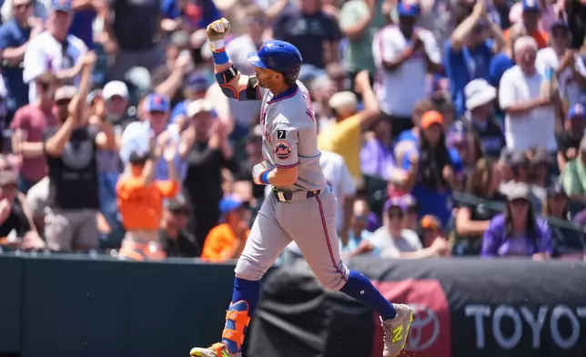 New York Mets' Jeff McNeil gestures to fans as he circles the bases after hitting a solo home run off Colorado Rockies starting pitcher Chase Dollander in the second inning of a baseball game, Sunday, June 8, 2025, in Denver. (AP Photo/David Zalubowski)