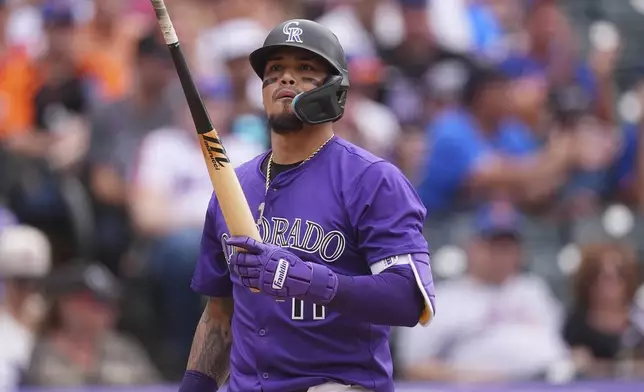 Colorado Rockies' Orlando Arcia reacts after striking out against New York Mets relief pitcher Paul Blackburn in the eighth inning of a baseball game Sunday, June 8, 2025, in Denver. (AP Photo/David Zalubowski)