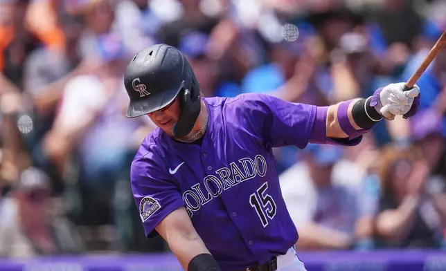 Colorado Rockies' Hunter Goodman reacts after striking out against New York Mets starting pitcher Tylor Megill to end the first inning of a baseball game, Sunday, June 8, 2025, in Denver. (AP Photo/David Zalubowski)