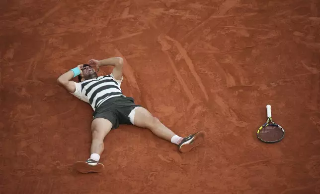 Spain's Carlos Alcaraz reacts after winning the final match of the French Tennis Open at the Roland-Garros against Italy's Jannik Sinner in Paris, Sunday, June 8, 2025. (AP Photo/Christophe Ena)