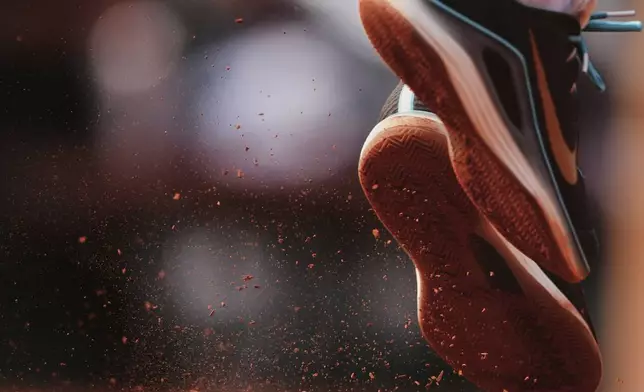 Spain's Carlos Alcaraz kicks the clay as he serves against Italy's Jannik Sinner during their final match of the French Tennis Open at the Roland-Garros stadium in Paris, Sunday, June 8, 2025. (AP Photo/Lindsey Wasson)