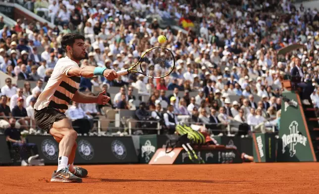 Spain's Carlos Alcaraz plays a shot against Italy's Jannik Sinner during their final match of the French Tennis Open at the Roland-Garros stadium in Paris, Sunday, June 8, 2025. (AP Photo/Lindsey Wasson)