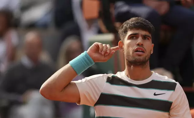 Spain's Carlos Alcaraz reacts after winning the third set against Italy's Jannik Sinner during their final match of the French Tennis Open at the Roland-Garros stadium in Paris, Sunday, June 8, 2025. (AP Photo/Thibault Camus)