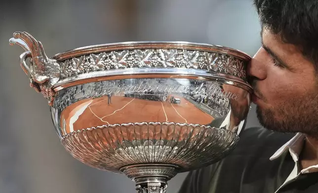 Spain's Carlos Alcaraz celebrates with the trophy after winning the final match of the French Tennis Open against Italy's Jannik Sinner at the Roland-Garros stadium in Paris, Sunday, June 8, 2025. (AP Photo/Thibault Camus)