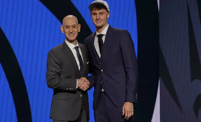 Cooper Flagg, right, poses for a photo with NBA commissioner Adam Silver after being selected first overall by the Dallas Mavericks In the first round of the NBA basketball draft, Wednesday, June 25, 2025, in New York. (AP Photo/Adam Hunger)
