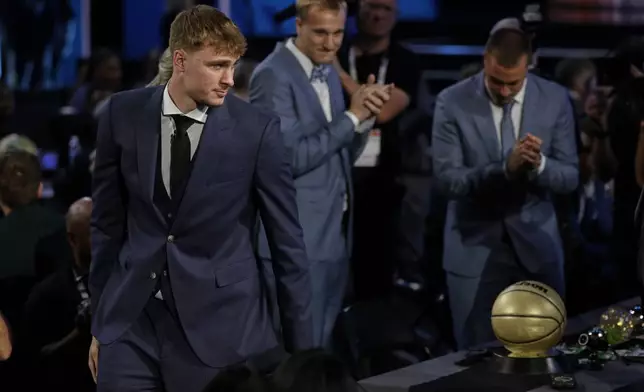 Cooper Flagg heads for the stage after being selected first overall by the Dallas Mavericks In the first round of the NBA basketball draft, Wednesday, June 25, 2025, in New York. (AP Photo/Adam Hunger)