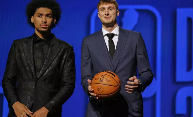 Dylan Harper, left, and Cooper Flagg gather for a photo before the start of the first round of the NBA basketball draft, Wednesday, June 25, 2025, in New York. (AP Photo/Adam Hunger)