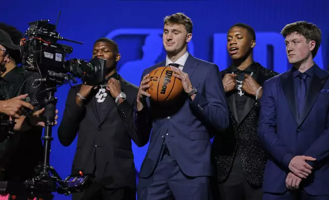 Cooper Flagg, center, poses for the camera along with Cedric Coward, far left, Thomas Sorber, second from right, and Kon Knueppel before the start of the first round of the NBA basketball draft, Wednesday, June 25, 2025, in New York. (AP Photo/Adam Hunger)