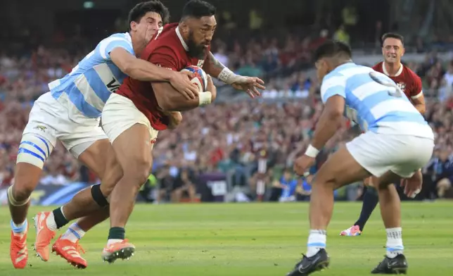 Lions' Bundee Aki drives forward as he runs on to score a try during the Rugby Union international match between the British and Irish Lions and Argentina, at the Aviva Stadium in Dublin, Friday, June 20, 2025. (AP Photo/Peter Morrison)
