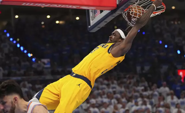 Indiana Pacers forward Pascal Siakam, top, dunks against the Oklahoma City Thunder during the second half of Game 5 of the NBA Finals basketball series Monday, June 16, 2025, in Oklahoma City. (AP Photo/Kyle Phillips)