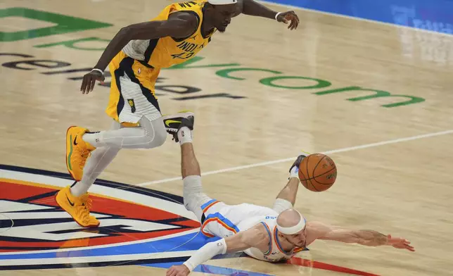 Oklahoma City Thunder guard Alex Caruso (9) dive for the loose ball as Indiana Pacers forward Pascal Siakam (43) pursues during the second half of Game 5 of the NBA Finals basketball series, Monday, June 16, 2025, in Oklahoma City. (AP Photo/Nate Billings)