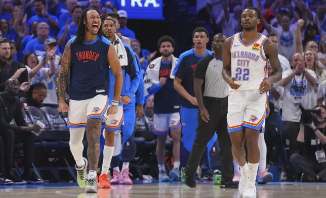 Oklahoma City Thunder players cheer during the second half of Game 5 of the NBA Finals basketball series against the Indiana Pacers, Monday, June 16, 2025, in Oklahoma City. (AP Photo/Kyle Phillips)
