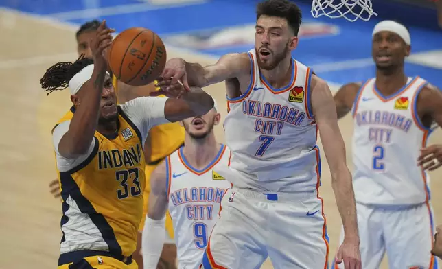 Oklahoma City Thunder forward Chet Holmgren (7) and Indiana Pacers center Myles Turner (33) battle for the ball during the second half of Game 5 of the NBA Finals basketball series, Monday, June 16, 2025, in Oklahoma City. (AP Photo/Nate Billings)