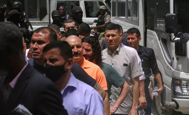 Colombians and Haitians accused of involvement in the 2021 assassination of Haitian President Jovenel Moise arrive to court in Port-au-Prince, Haiti, Monday, June 9, 2025.(AP Photo/Odelyn Joseph)