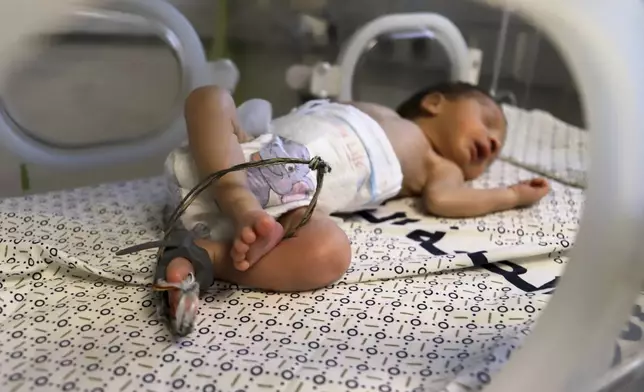 A prematurely born baby lies in an incubator at the neonatal intensive care unit of Nasser Hospital in Khan Younis, southern Gaza Strip, Thursday, June 19, 2025. (AP Photo/Mariam Dagga)