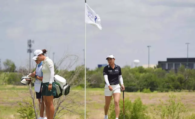 Jeeno Thitikul, right, and Minjee Lee prepare to putt on the first green during the third round of the Women's PGA Championship golf tournament, Saturday, June 21, 2025, in Frisco, Texas. (AP Photo/LM Otero)
