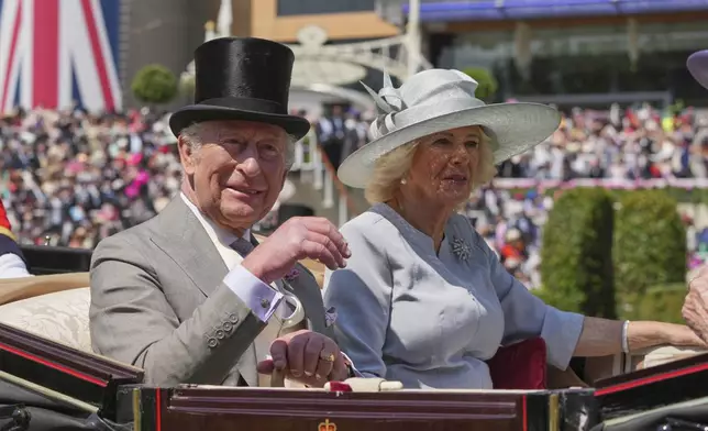 Britain's King Charles and Queen Camilla arrive by carriage into the Parade Ring on the third day of the Royal Ascot horse race meeting, traditionally called Ladies Day, at Ascot, England, Thursday, June 19, 2025. (AP Photo/Kin Cheung)