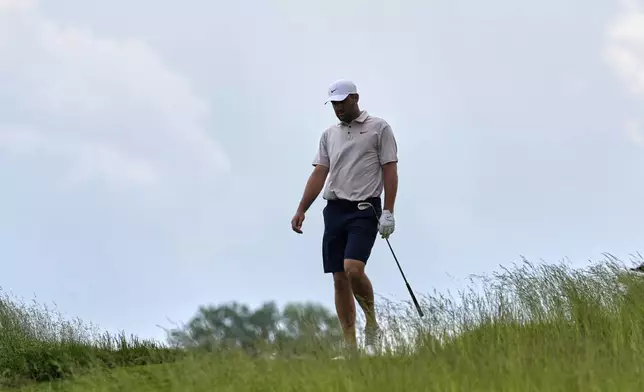 Scottie Scheffler walks down the sixth fairway during a practice round ahead of the U.S. Open golf tournament at Oakmont Country Club Tuesday, June 10, 2025, in Oakmont, Pa. (AP Photo/Seth Wenig)