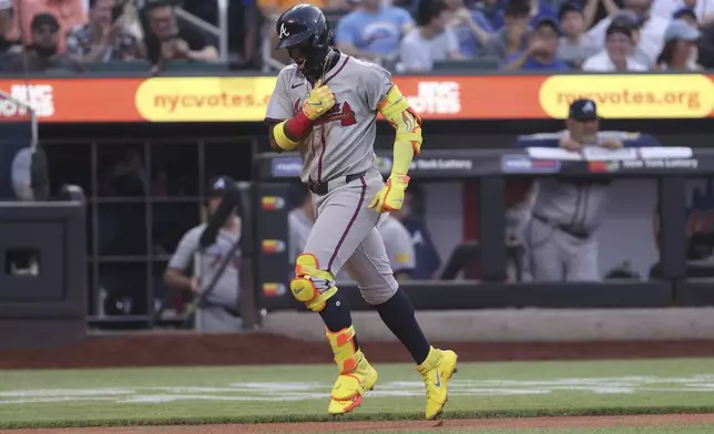 Atlanta Braves' Ronald Acuña Jr. reacts after hitting a home run during the third inning of a baseball game against the New York Mets, Monday, June 23, 2025, in New York. (AP Photo/Pamela Smith)