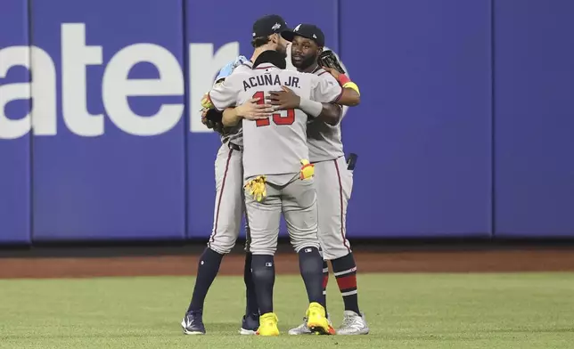 From left to right, Atlanta Braves outfielders Eli White, Ronald Acuña Jr. and Michael Harris II react after defeating the New York Mets in a baseball game Monday, June 23, 2025, in New York. (AP Photo/Pamela Smith)