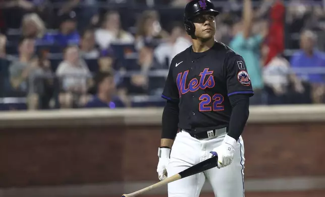 New York Mets' Juan Soto walks to the dugout after being struck out by Atlanta Braves pitcher Dylan Lee during the eighth inning of a baseball game Monday, June 23, 2025, in New York. (AP Photo/Pamela Smith)