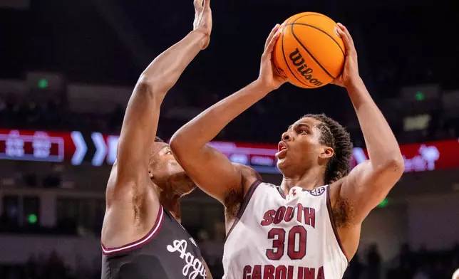 FILE - South Carolina forward Collin Murray-Boyles (30) shoots on Texas A&amp;M forward Pharrel Payne (21) during the second half of an NCAA college basketball game Saturday, Feb. 1, 2025, in Columbia, S.C. (AP Photo/Scott Kinser, File)