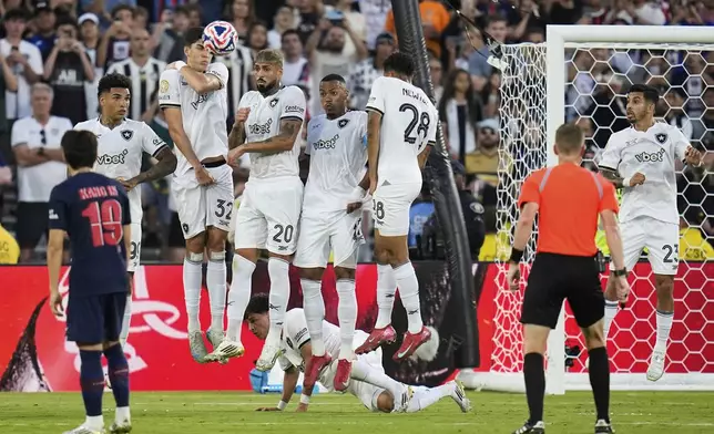 Botafogo defenders react as a free kick goes over them during the Club World Cup group B soccer match between PSG and Botafogo in Pasadena, Calif., Thursday, June 19, 2025. (AP Photo/Gregory Bull)