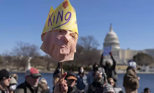 FILE - People take part in the "No Kings Day" protest on Presidents Day in Washington, in support of federal workers and against recent actions by President Donald Trump and Elon Musk, Monday, Feb. 17, 2025, by the Capitol in Washington. (AP Photo/Jose Luis Magana,File)