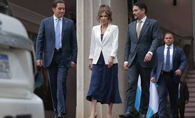 U.S. Homeland Security Secretary Kristi Noem, center, leaves the president's residence alongside Honduran Foreign Minister Javier Bu, right, and presidential private secretary Hector Zelaya, in Tegucigalpa, Honduras, Wednesday, June 25, 2025. (Anna Moneymaker/Pool photo via AP)