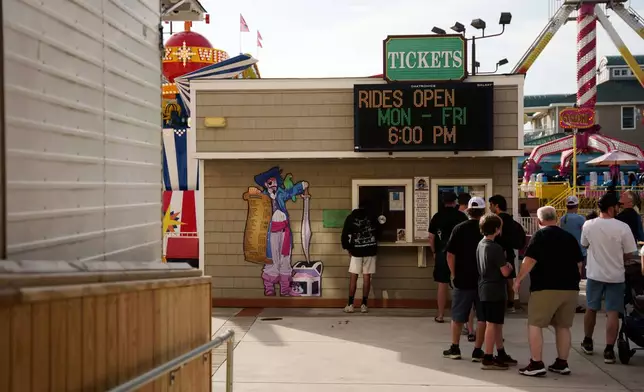 People line up for tickets at Playland's Castaway Cove amusement park, in Ocean City, N.J, on Friday, June 6, 2025. (AP Photo/Mingson Lau)