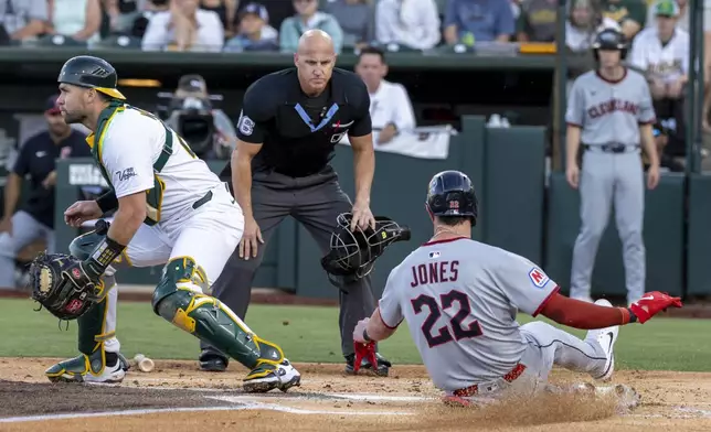Cleveland Guardians' Nolan Jones (22) scores during the second inning of a baseball game against the Athletics Saturday, June 21, 2025, in West Sacramento, Calif. (AP Photo/Sara Nevis)