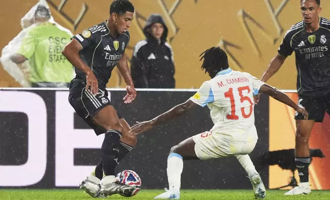 Real Madrid's Jude Bellingham, left, and Red Bull Salzburg's Mamady Diambou compete for the ball during the Club World Cup Group H soccer match between Salzburg and Real Madrid in Philadelphia, Thursday, June 26, 2025. (AP Photo/Matt Slocum)