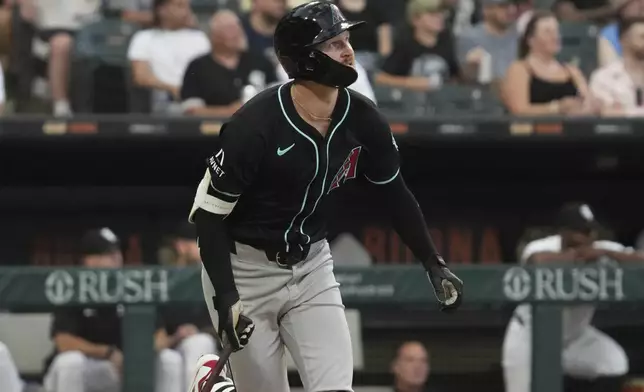 Arizona Diamondbacks' Pavin Smith watches his solo home run during the fourth inning of a baseball game against the Chicago White Sox in Chicago, Monday, June 23, 2025. (AP Photo/Nam Y. Huh)