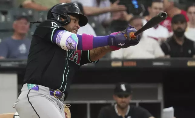 Arizona Diamondbacks' Ketel Marte hits a solo home run during the fourth inning of a baseball game against the Chicago White Sox in Chicago, Monday, June 23, 2025. (AP Photo/Nam Y. Huh)