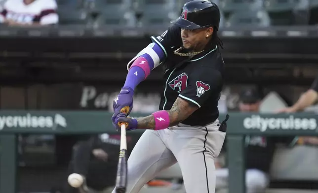 Arizona Diamondbacks' Ketel Marte hits a single during the first inning of a baseball game against the Chicago White Sox in Chicago, Monday, June 23, 2025. (AP Photo/Nam Y. Huh)