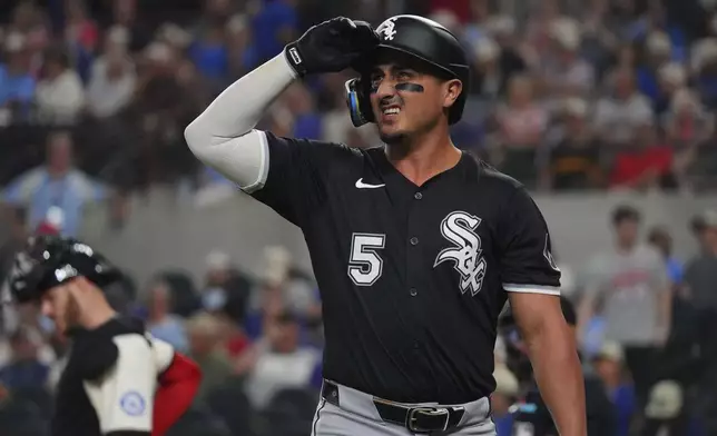 Chicago White Sox's Josh Rojas heads to the dugout after striking out during the third inning of a baseball game against the Texas Rangers, Friday, June 13, 2025, in Arlington, Texas. (AP Photo/LM Otero)