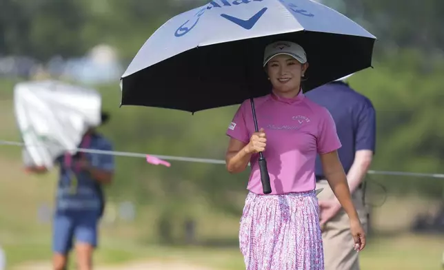 Yui Kawamoto, of Japan, uses an umbrella for the sun during the second round of the Women's PGA Championship golf tournament Friday, June 20, 2025, in Frisco, Texas. (AP Photo/LM Otero)