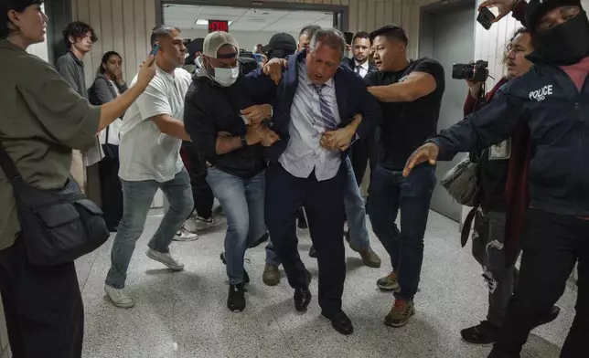 New York City Comptroller Brad Lander is placed under arrest by Immigration and Customs Enforcement (ICE) and FBI agents outside federal immigration court on Tuesday, June 17, 2025, in New York. (AP Photo/Olga Fedorova)