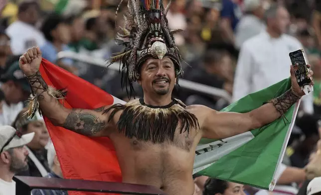 A Mexico fan holds up a flag before a CONCACAF Gold Cup soccer match between Mexico and Costa Rica, Sunday, June 22, 2025, in Las Vegas. (AP Photo/John Locher)