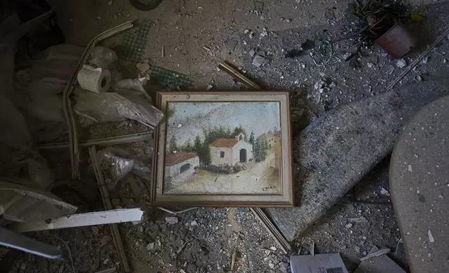 A painting and personal belongings are covered with dust and shards of broken glass in a home struck by an Iranian missile in Ramat Gan, Israel, on Thursday, June 19, 2025. (AP Photo /Oded Balilty)