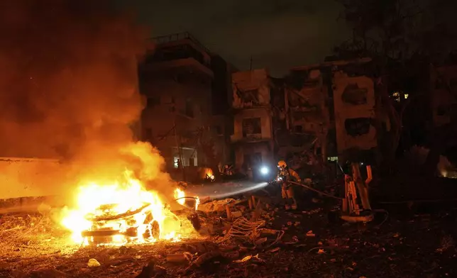 Firefighters work to extinguish a blaze after a missile launched from Iran struck Tel Aviv, Israel, Monday, June 16, 2025. (AP Photo/Baz Ratner)